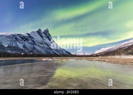 Die verschneiten Gipfel der Otertinden und das Nordlicht in der Polarnacht Oteren, Lyngen Alpen, Troms, Norwegen Stockfoto