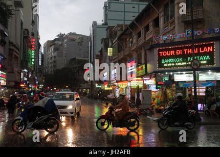 Schweren Monsunregen. Motorroller auf Saigon Street. Vietnam. Stockfoto