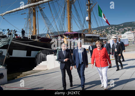 HANDOUT - Handout Bild datiert 12. Juli 2017 zeigt Bundeskanzlerin Angela Merkel (von rechts nach links), italienische Ministerpräsident Paolo Gentiloni und der französische Präsident Emmanuel Macron zu Fuß vor der Schule versenden Goletta Palinuro nach geben eine gemeinsame Presseerklärung vor der Westbalkan-Gipfel in Triest, Italien. Dieses Treffen fand im Vorfeld des Gipfels mit sechs West-Balkan-Staaten zusammen mit mehreren EU-Ländern in der nördlichen Stadt Triest.  (ACHTUNG REDAKTION: REDAKTIONELLE NUTZUNG NUR IN VERBINDUNG MIT AKTUELLEN BERICHTERSTATTUNG / OBLIGATORISCH CREDITS) Foto: Guido Bergmann/Bundesregie Stockfoto