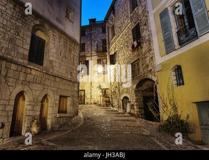 Gepflasterte Gasse in der Altstadt Peille nachts, Frankreich. Stockfoto