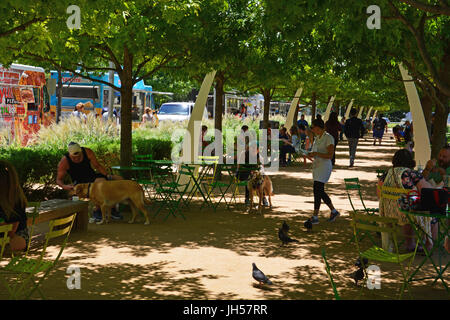 Bewohner zu entkommen die Mitte Tag Hitze im Schatten der Eichen im Klyde Warren Deck Park in der Innenstadt von Dallas Texas Stockfoto