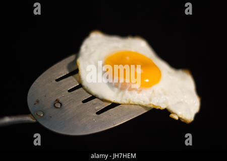 Foto von einem Spiegelei und Spachtel aus Metall Stockfoto