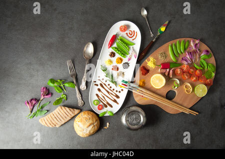 Bunte Kräuter Gewürze und frische Zutaten auf einer Maler-palette Stockfoto