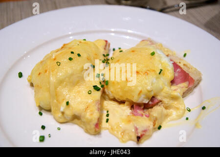 Wien, Österreich - 30. April 2017: Eggs Benedict - getoasteten englischen Muffins, Schinken, Spiegeleiern und köstliche buttrige Sauce Hollandaise Stockfoto