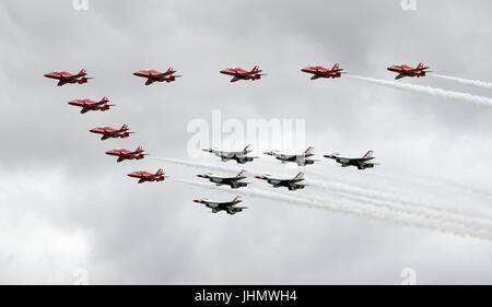 Die roten Pfeile fliegen in Formation zusammen mit dem USAF Thunderbirds Display Team wie sie den Flugvorführungen in 2017 Royal International Air Tattoo an RAF Fairford in Gloucestershire öffnen. Stockfoto