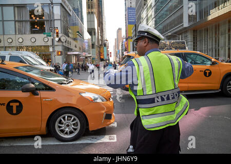 NYPD Traffic Officer mit Pfeife im Mund, die Regelung des Verkehrs auf der 6. Ave New York City USA Stockfoto