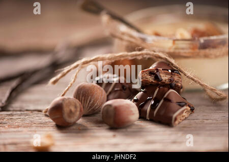 Schokolade Haselnüsse auf Holztisch Hintergrund Stockfoto