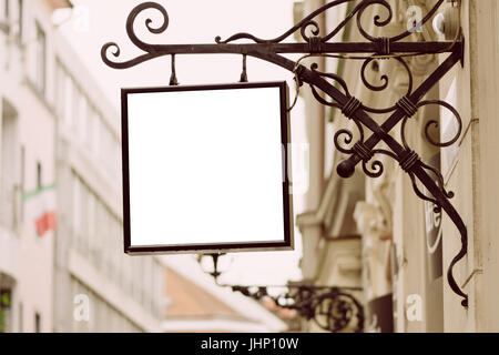 Leere Quadrat Schild, klassische Architektur Gebäude Hintergrund von Schmiedeeisen Halterung, in der Stadt hängen. Stockfoto