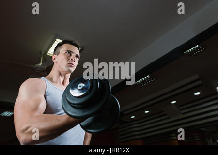 Bodybuilder trainieren Bizeps - Kurzhantel Konzentrationscurls Stockfoto