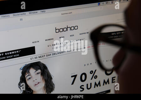Eine Frau schaut der Boohoo.com-Website auf einem Computer-Bildschirm Stockfoto