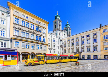 Linz, Österreich. Alte Kathedrale (Alter Dom) und touristischen Zug in der Plaza Mayor (Hauptplatz) Stockfoto