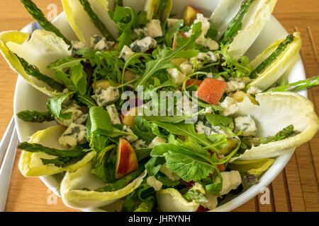 Salat Sommer in weißes Geschirr Schale, mit Rucola, Chicoree, Radicchio, Spargel, Nektarinen, Roquefort und lemon Vinaigrette. Stockfoto