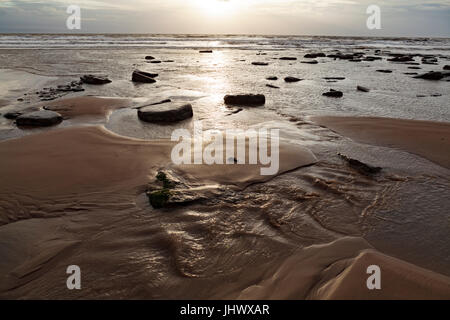 Die reflektierenden Sonne Wasser an einem Strand in South Wales Stockfoto