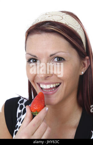 Junge Frau isst frische Erdbeeren - junge Frau isst Erdbeere, Junge Frau Isst Frische Erdbeeren - junge Frau isst Erdbeer Stockfoto