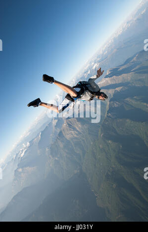 Ein Fallschirmspringer tracking oberhalb Locarno, Schweiz mit den Alpen im Hintergrund Stockfoto