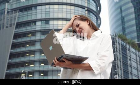 Gestresste Geschäftsfrau mit Laptop-Computer konnte nicht viel. Unglückliche Frau in Panik Stockfoto