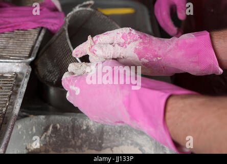 Ein Mitglied des Personals bereitet Brathähnchen bei KFC im England, UK. Stockfoto