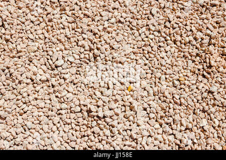 Kleine Stücke von Steinen auf dem Boden. Felsen hellrot. Stockfoto
