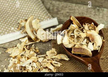 Getrocknete Pilze in Holztisch. Haufen von getrockneten Speisepilzen zu verkaufen Stockfoto