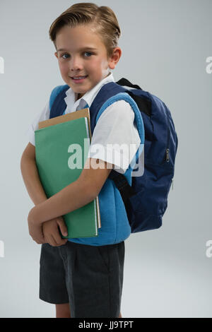 Porträt der glückliche Schüler mit Büchern Stockfoto