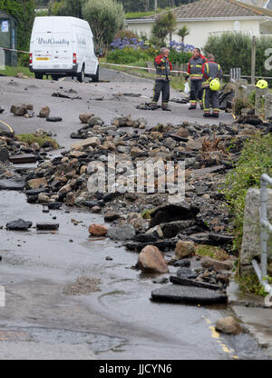 Notdienste-Umfrage die Schäden an einer Straße in Coverack, Cornwall, nach intensivem Regen verursachte Sturzfluten in dem Dorf an der Küste. Stockfoto