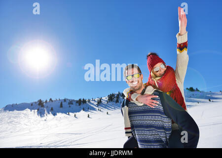 Liebespaar im Schnee draußen zusammen zu spielen. Stockfoto