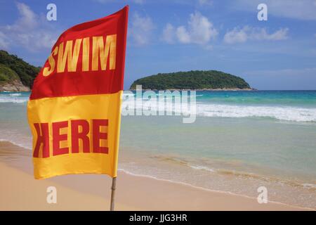 Schwimmen Sie hier Flagge am Nai Harn Beach, Phuket, Thailand Stockfoto