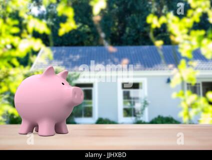 3D Rosa Sparschwein gegen Haus door(blurred) Stockfoto