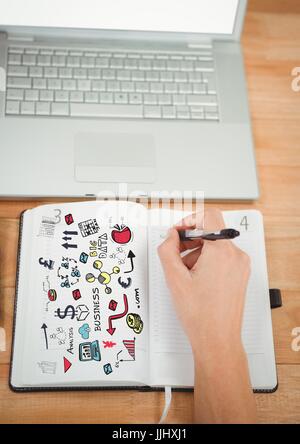 Business-Kritzeleien auf Notizblock mit Hand schreiben und laptop Stockfoto