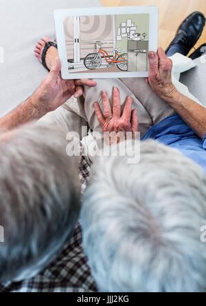Älteres Paar auf dem Sofa mit Tablet (Draufsicht). Auf die Gestaltung des neuen Raumes (Farbe: grün, tablet Stockfoto