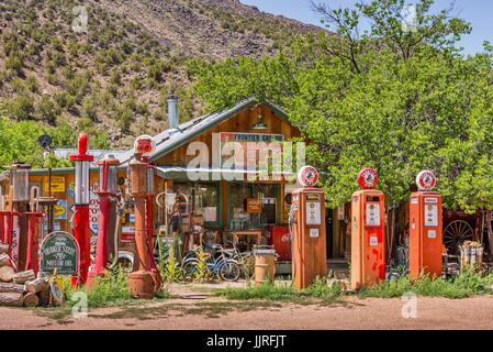 Alte Gaspumpen, antike Schilder und Erinnerungsstücke an Tankstellen im Klassischen Gasmuseum in Embudo, in der Nähe von Taos, New Mexico, USA. Stockfoto