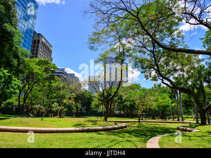 Manila, Philippinen - 14. April 2017. Gärten und Wolkenkratzer sieht man bei Ayala Triangle Park in Makati, Metro Manila. Stockfoto