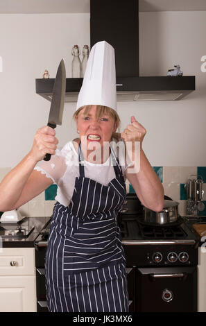 Porträt eines sehr wütend Chefs mit einem scharfen Küchenmesser in eine bedrohliche Weise Stockfoto