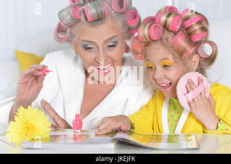 Portrait einer älteren Frau und Enkelin lesen Magazin Stockfoto