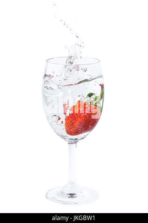 frische Erdbeeren fiel ins Wasser im Weinglas mit Schuss auf weißem Hintergrund Stockfoto