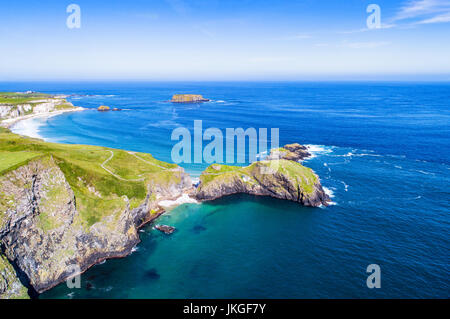 Carrick-a-Rede Rope Bridge, National Trust. an der Causeway-Küste im County Antrim, Nordirland, Vereinigtes Königreich. Weit Luftbild mit Klippen und Schafe Insel Stockfoto