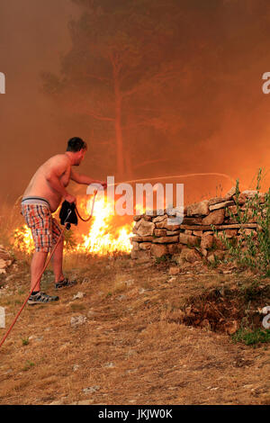 Zrnovnica, Split, Kroatien - 17. Juli 2017: Mann im Kampf mit den massiven Lauffeuer brennen die Wälder und Dörfer in der Umgebung der Stadt Split Stockfoto