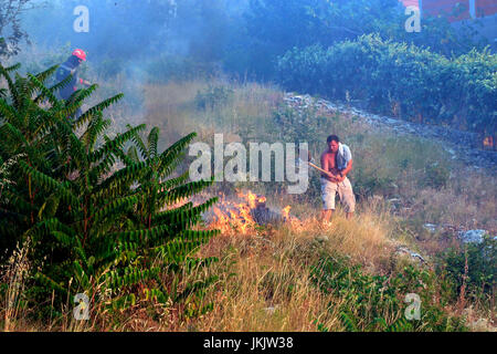 Zrnovnica, Split, Kroatien - 17. Juli 2017: Mann im Kampf mit den massiven Lauffeuer brennen die Wälder und Dörfer in der Umgebung der Stadt Split Stockfoto