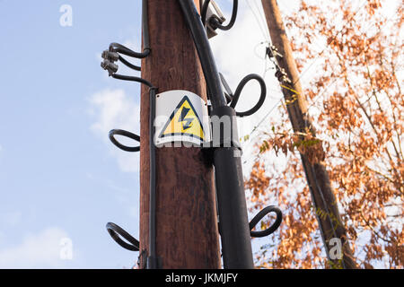 Hochspannungs-Schild an einem Mast Stockfoto