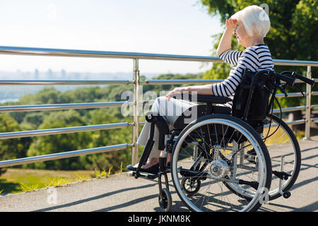 Sehr inspiriert senior Frau sitzt im Rollstuhl Stockfoto