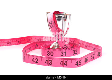 Maßband rot markiert in Zoll rollte herum kleine Silber Sport Cup, isoliert auf weißem Hintergrund Stockfoto