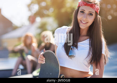 Teenager-Mädchen stehen mit ihrem skateboard Stockfoto