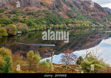 Reflexionen in Llyn Dinas mit Fischer in einem Boot Nant Beddgelert Gwynant Valley in der Nähe von Snowdonia National Park North Wales UK Oktober 50500 Stockfoto