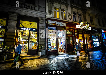 Käufer und Touristen gehen für einige Abend einkaufen in der Praha Bezirk von Prag. Die Geschäfte sind gut beleuchtet, mit stimmungsvoller Beleuchtung Stockfoto
