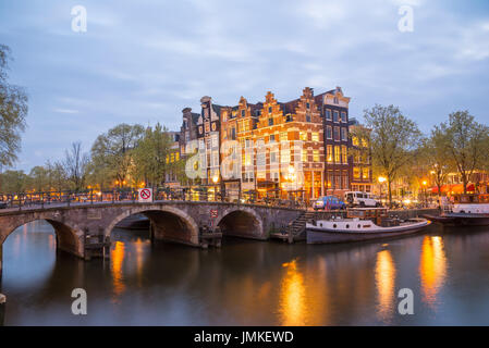 Blick auf die Amsterdamer Grachten und Böschungen entlang sie nachts. Stockfoto