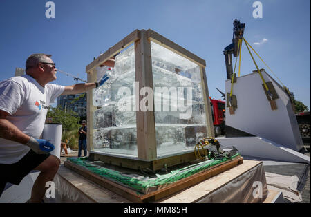 Vancouver, Kanada. 27. Juli 2017. Arbeiter stapeln sich Eisblöcke während der Ice Box Challenge in Vancouver, Kanada, 27. Juli 2017. Ice Box Challenge ist eine öffentliche Experiment, um die Vorteile von super energieeffiziente Gebäude unter den Passivhaus standard demonstrieren. Zwei kleine Haus-wie Boxen gebaut mit Passivhaus-Standard und lokale Baubeschrieb Code sitzen nebeneinander unter Freifläche für 18 Tage mit einem ein-Tonnen-Block Eis ummantelt, um die neue Zero bezeugen Emission Baustandard. Bildnachweis: Liang Sen/Xinhua/Alamy Live-Nachrichten Stockfoto