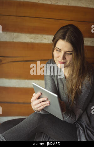 Lächelnde Frau mit digital-Tablette zu Hause Stockfoto