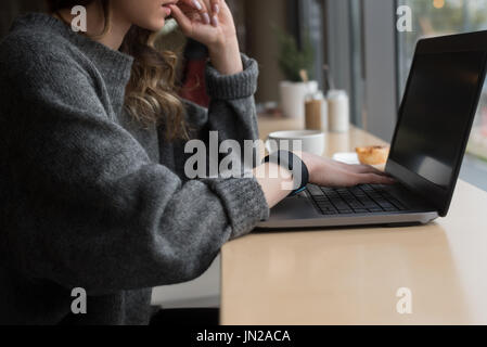 Mittleren Bereich der Frau mit Laptop im café Stockfoto