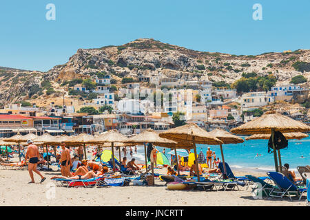 Insel Kreta, Griechenland, 9. Juni 2017: Panorama der Matala Strand. Höhlen auf den Felsen dienten als einen römischen Friedhof und auf das Jahrzehnt der 70er Jahren lebten Stockfoto