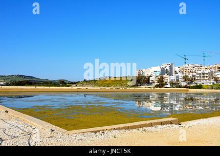 Blick auf die Salinen mit Gebäuden und Bau-Krane nach hinten in Salina Bay, Bugibba, Malta, Europa. Stockfoto